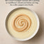 Bowl of parsnip velouté garnished with Alexian Sliced Black Pepper Mousse 5oz swirl