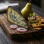 Blue cheese wedge with pear and accompaniments showcasing Bleu d’Auvergne French blue cheese