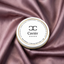 A white and gold-lidded caviar tin labeled caviér with sustainable hand picked text around its edge