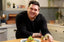 Smiling chef with food.