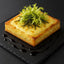 Flaky pastry topped with cheese and greens featuring French Raclette Cheese for gourmet flavor