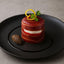 Prosciutto-wrapped tomato and mozzarella tower with Marcos Iberico Leg Bone In in bone-in presentation