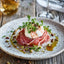 Prosciutto Pio Tosini with Burrata and Prosciutto Appetizer on a Charcuterie Board
