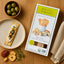 Box of organic sourdough flatbread featuring sweet onion crème fraîche from rustic bakery