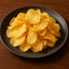 Pile of golden Torres Fried Egg Potato Chips with egg yolk flavor display