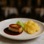 Seared foie gras with sauce served alongside Torres Potato Chips Black Truffle flavor