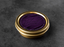 A luxurious gold-toned metal tin containing deep purple velvet caviar with elegant script labeling on the lid